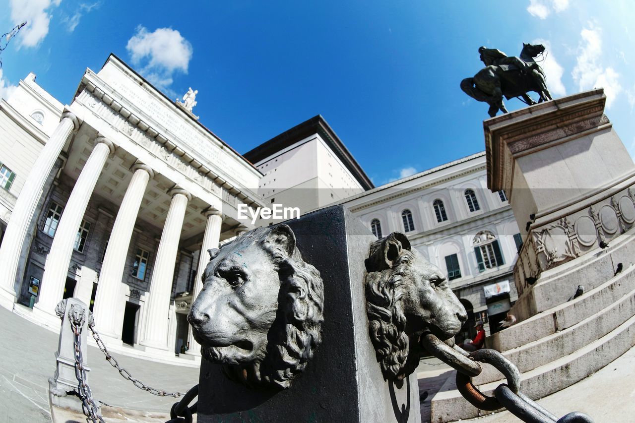 LOW ANGLE VIEW OF STATUE IN FRONT OF BUILDINGS