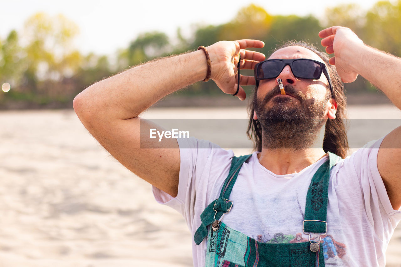 Portrait of man wearing sunglasses standing outdoors