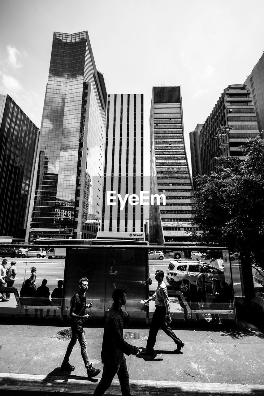 PEOPLE WALKING ON BUILDINGS IN CITY