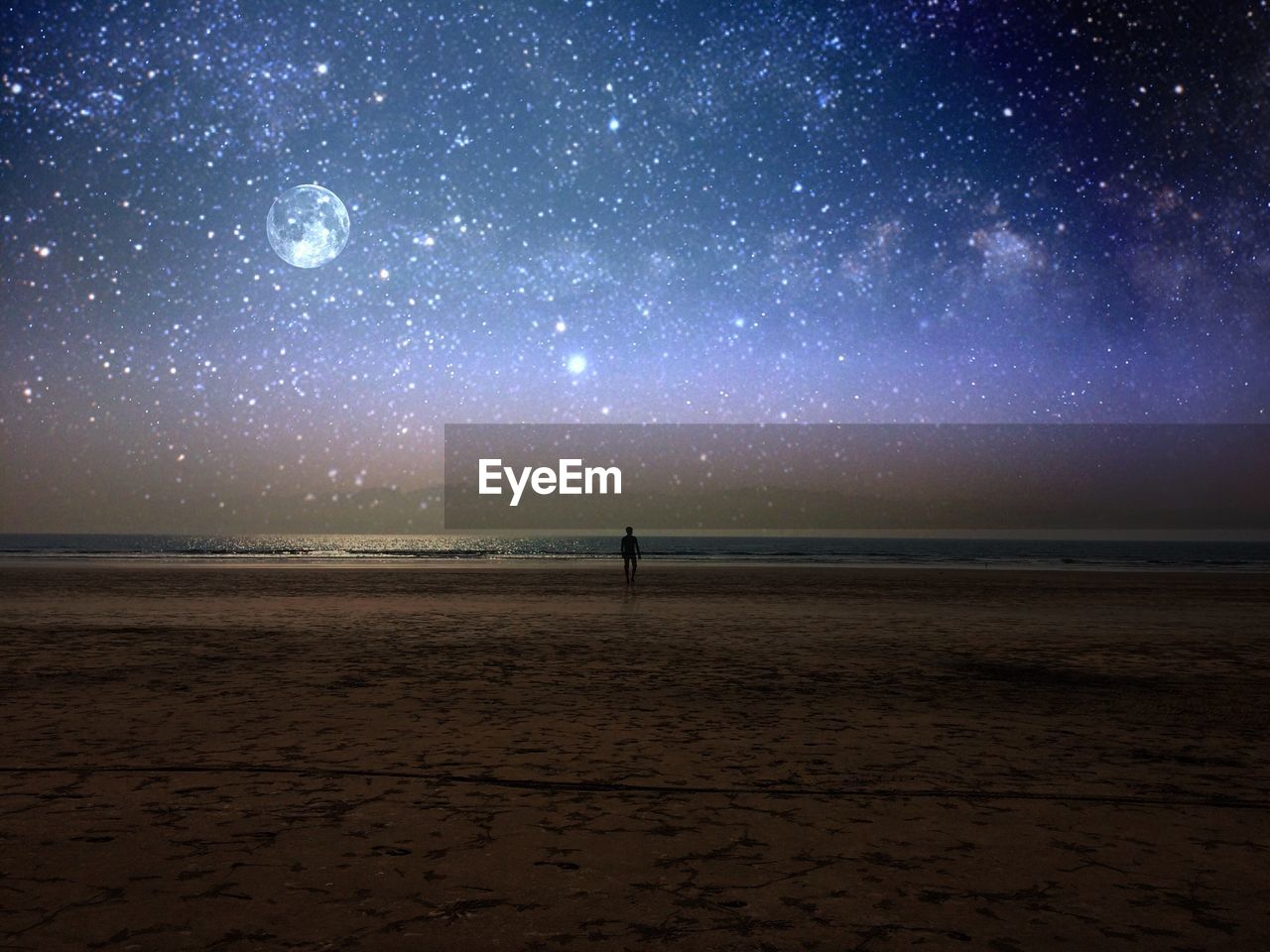 Scenic view of beach against sky at night