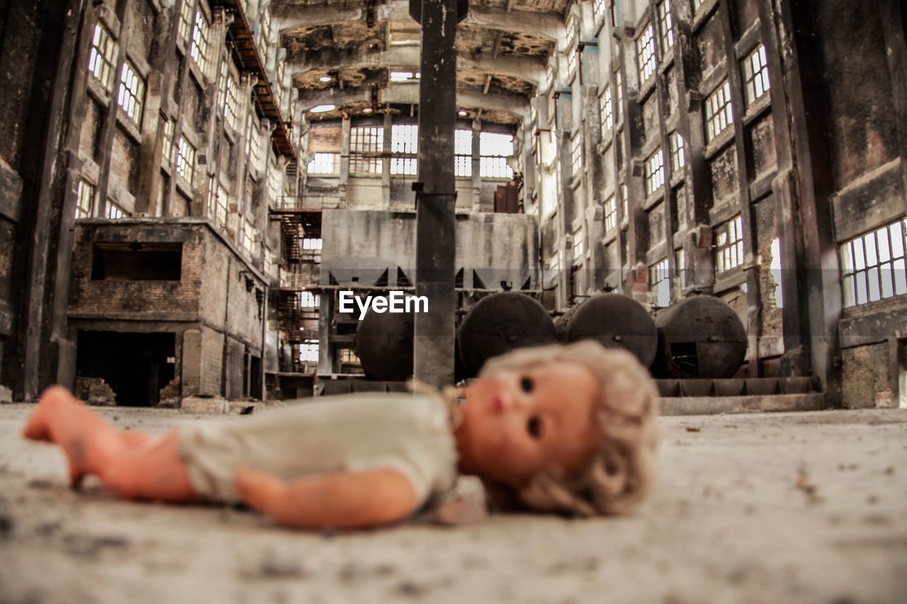 Close-up of doll in abandoned factory