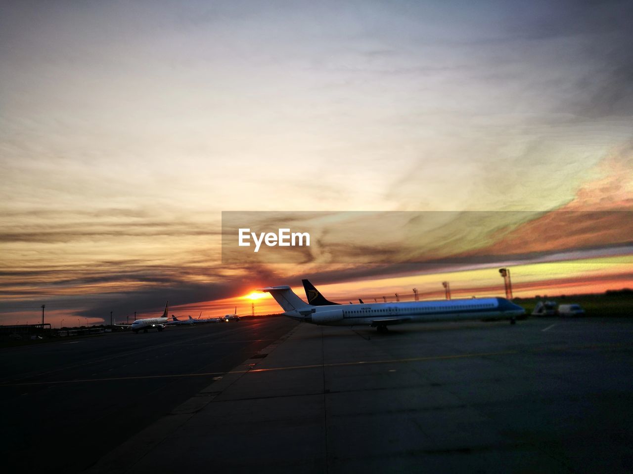 AIRPORT RUNWAY AGAINST SKY DURING SUNSET