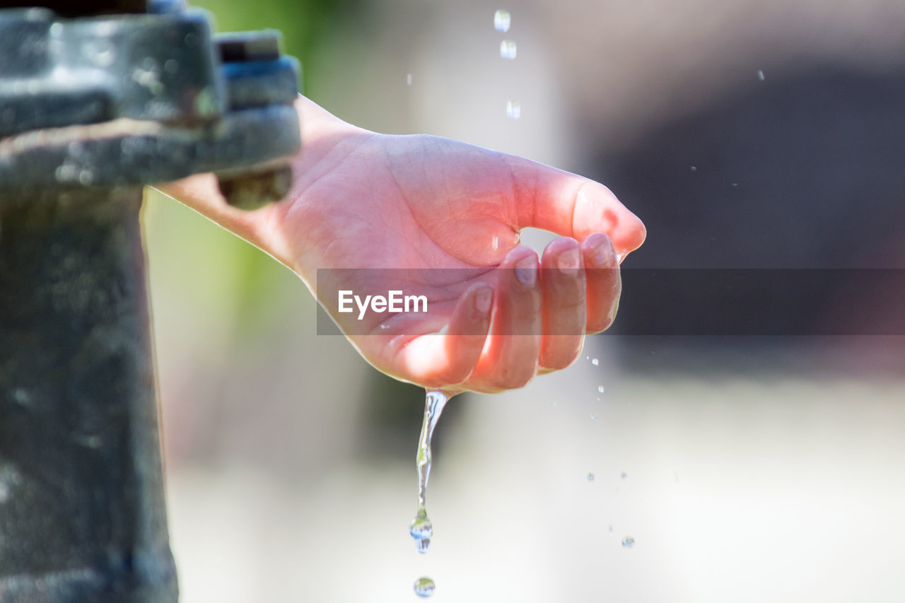 CLOSE-UP OF HANDS HOLDING WATER