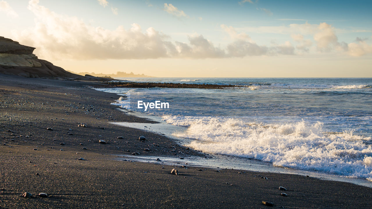 SCENIC VIEW OF BEACH DURING SUNSET