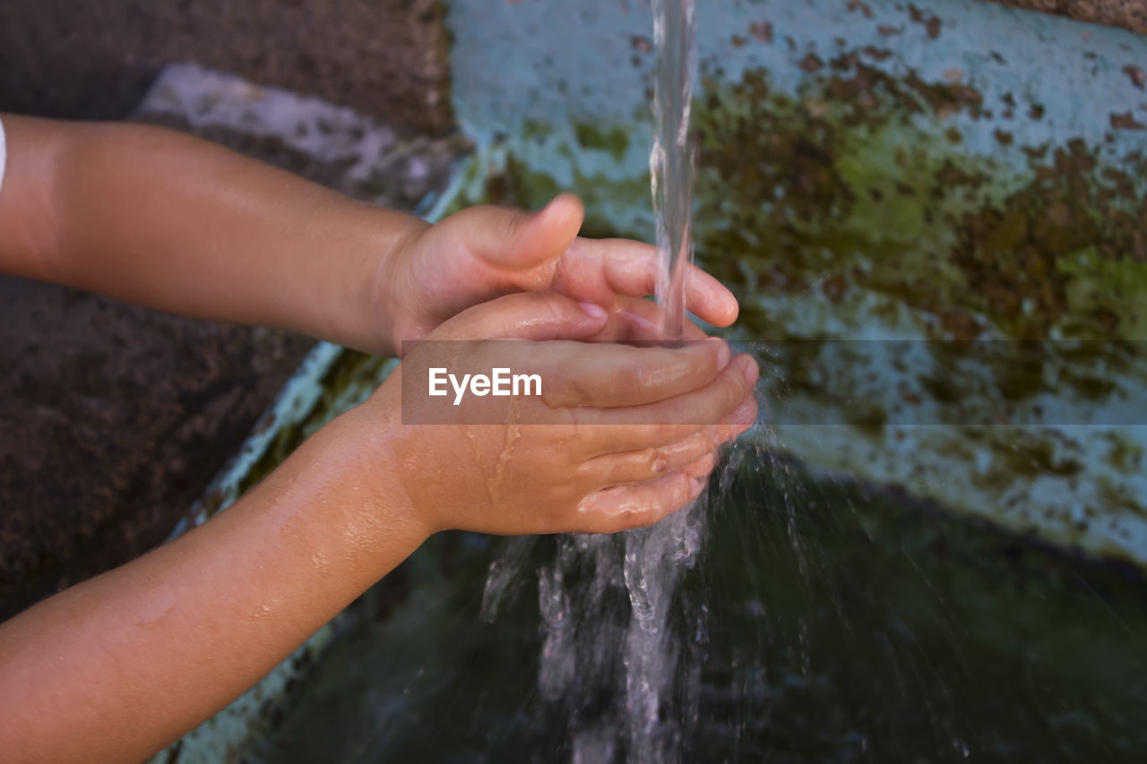 High angle view of kid washing hands