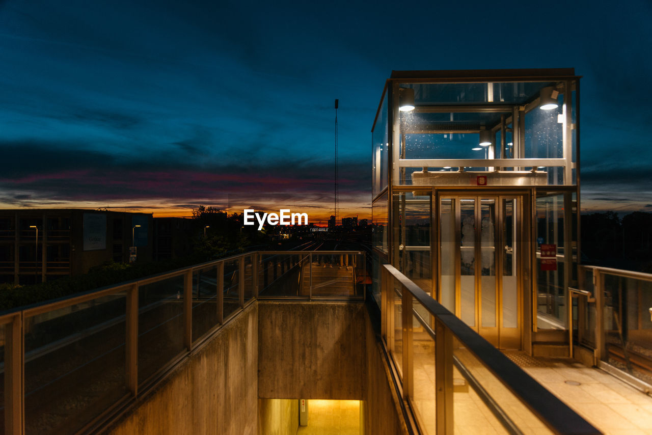 Illuminated building against sky at dusk