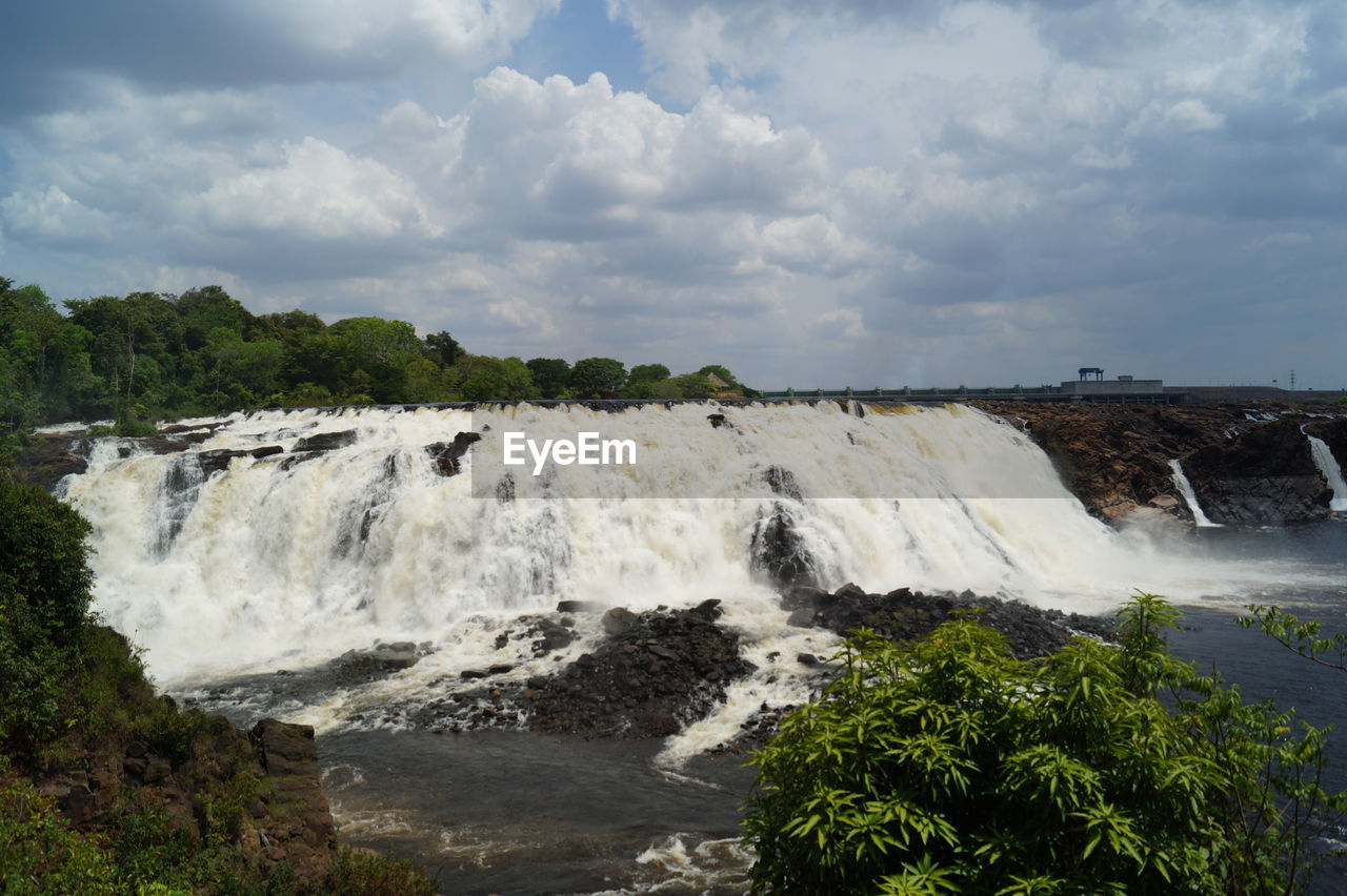 PANORAMIC VIEW OF WATERFALL AGAINST SKY