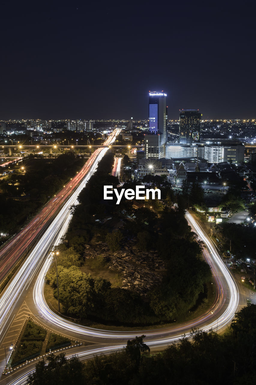 HIGH ANGLE VIEW OF LIGHT TRAILS ON ROAD