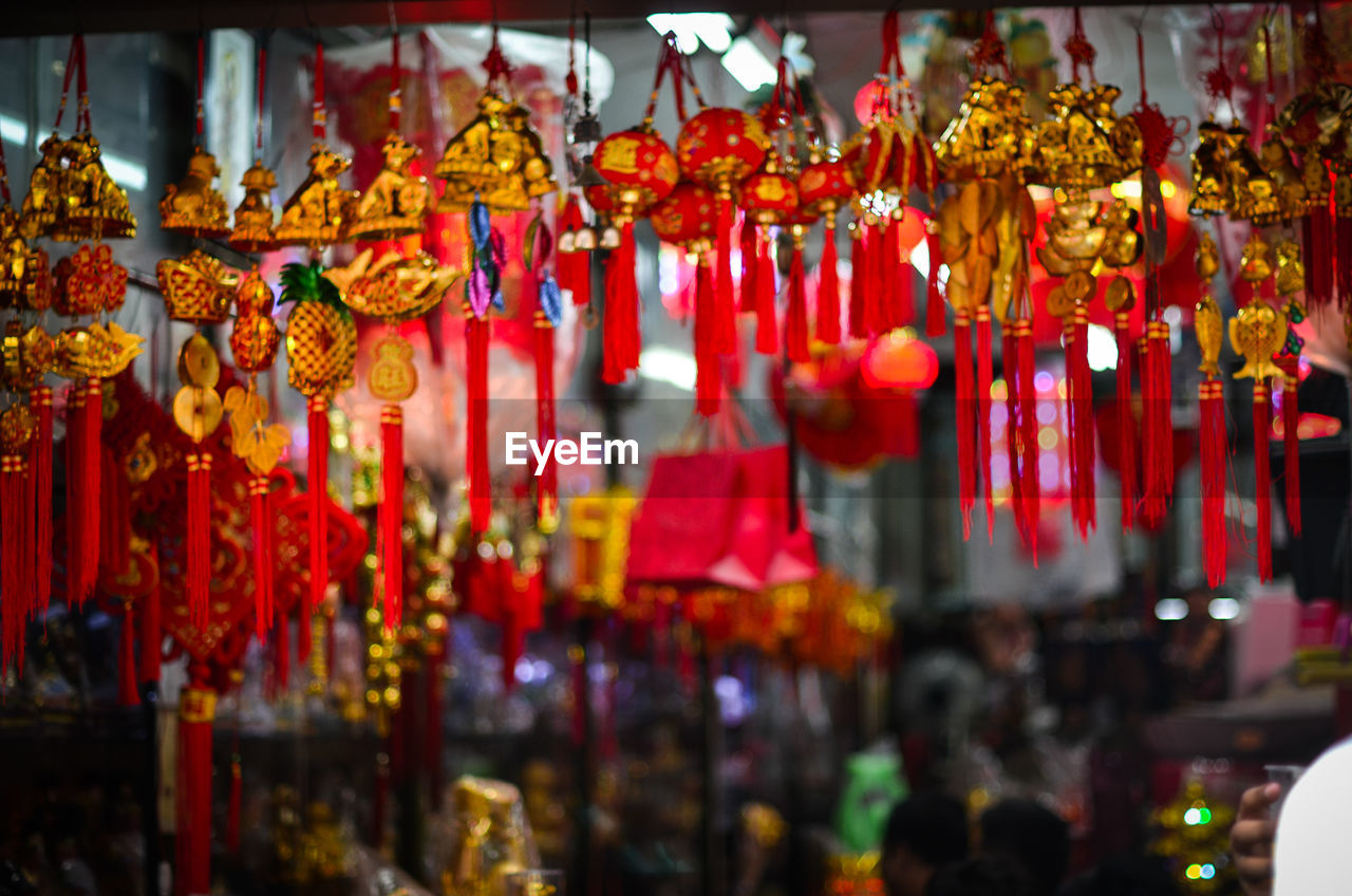 Close-up of decorations hanging at market for sale