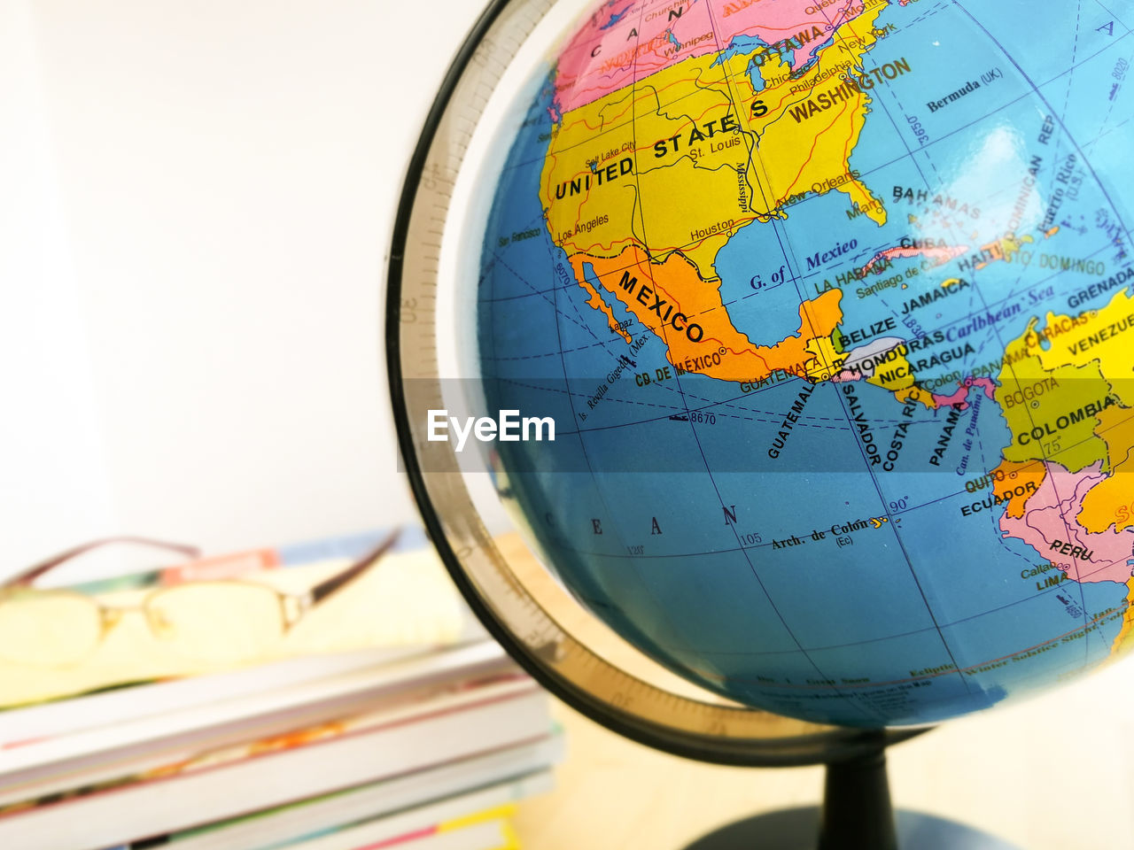 Countries and continents with colorful map on globe with books in the background. education concept.