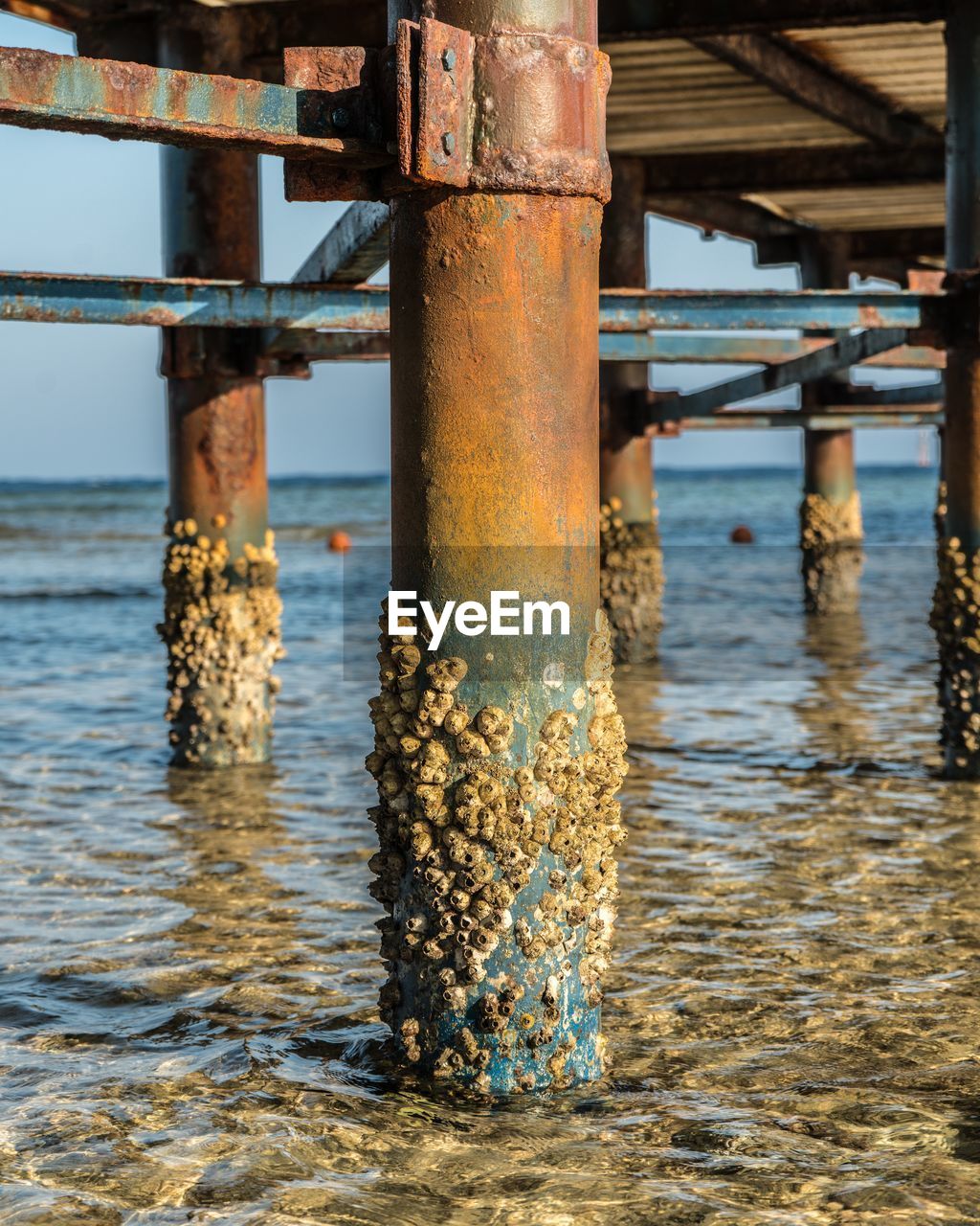 View of rusty pier over sea