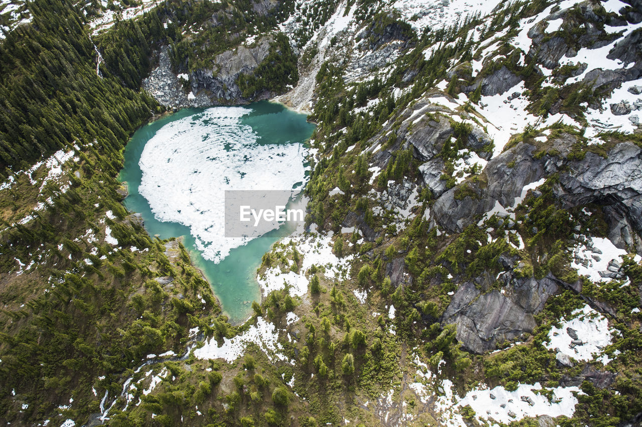 Aerial view of ice melting off alpine alpine lake, spring has arrived!