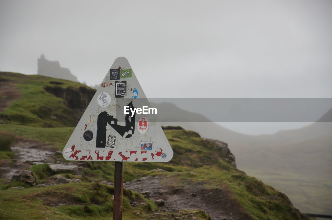 INFORMATION SIGN AGAINST MOUNTAIN