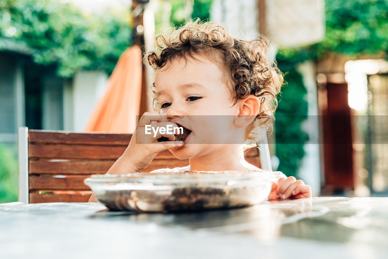 Portrait of boy looking away on table