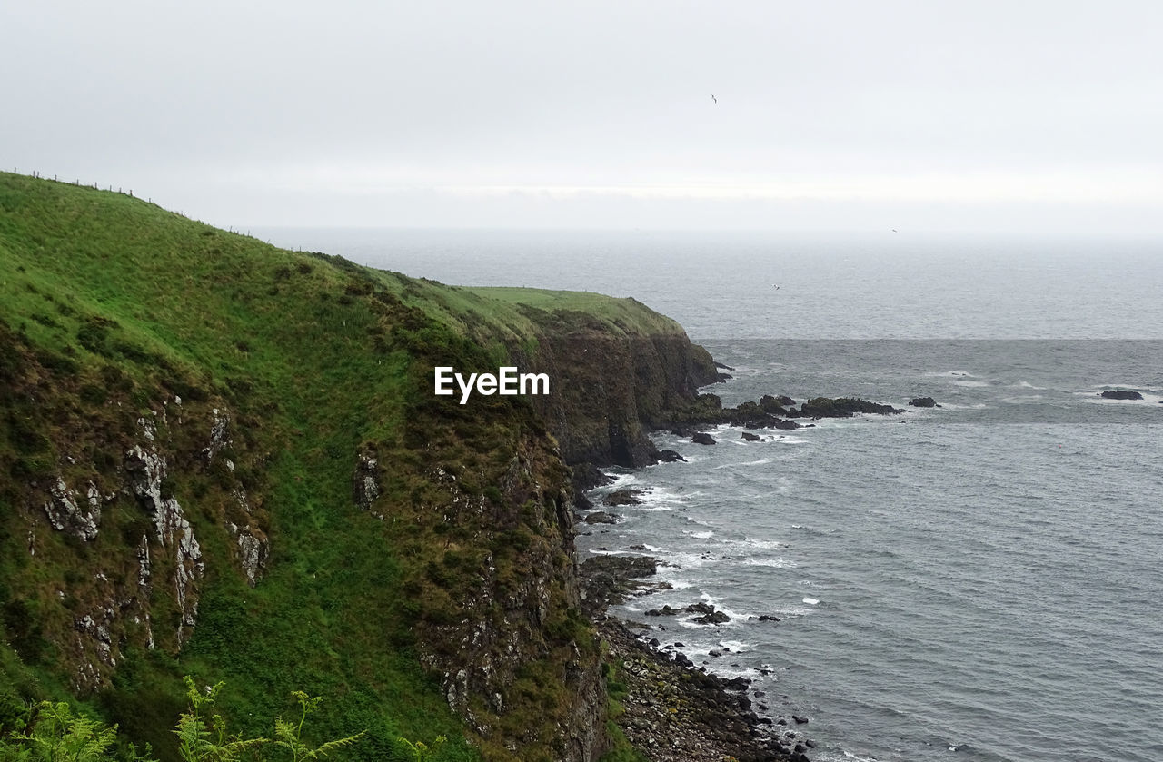 SCENIC VIEW OF SEA AND ROCKS AGAINST SKY