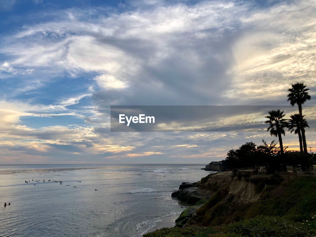 SCENIC VIEW OF BEACH AT SUNSET