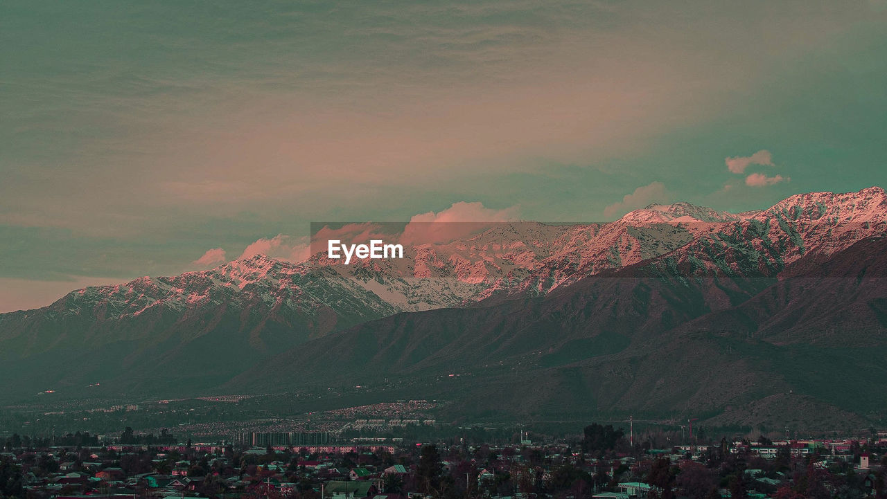 AERIAL VIEW OF CITYSCAPE AGAINST SKY AT SUNSET