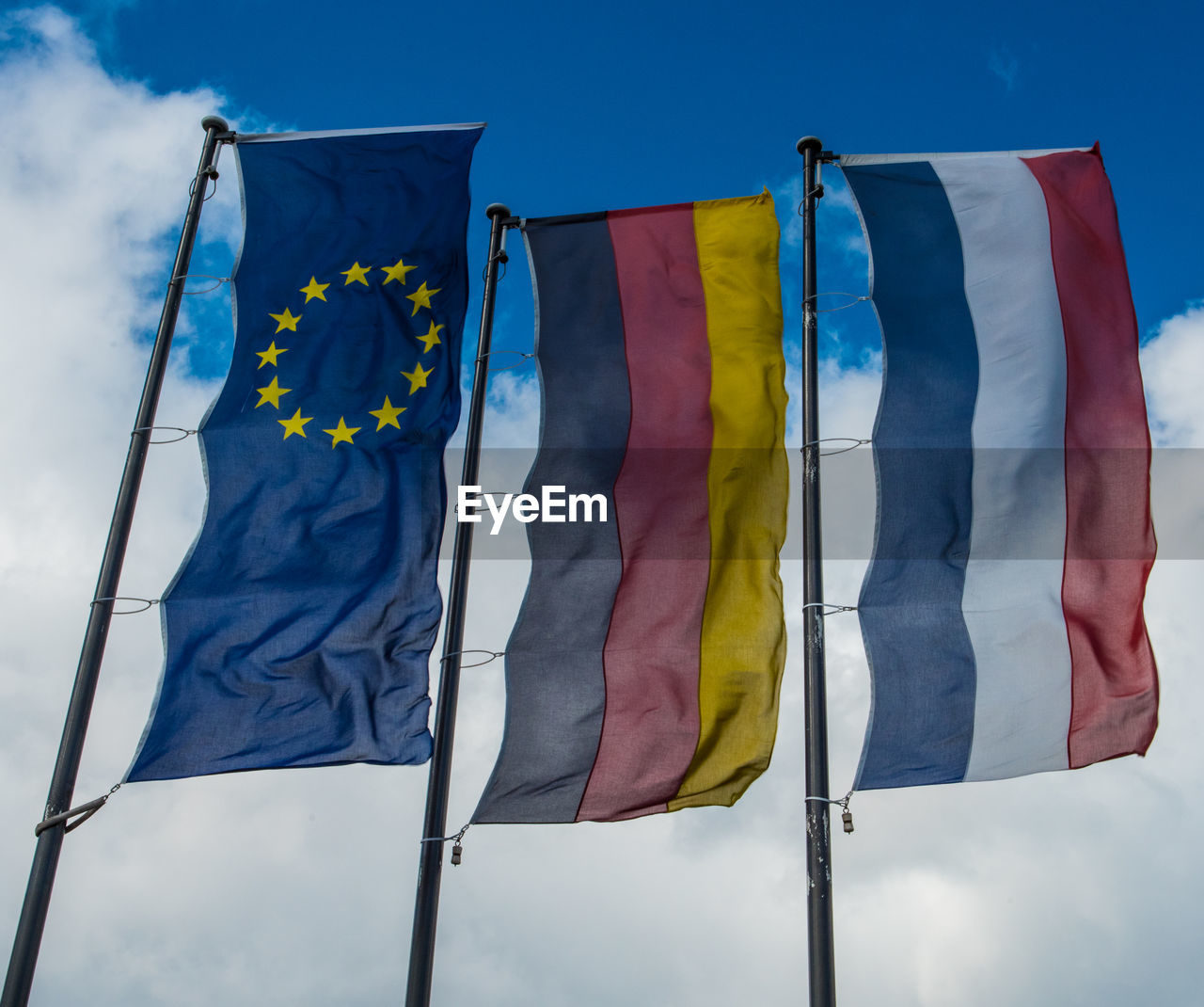 LOW ANGLE VIEW OF FLAGS FLAG AGAINST BLUE SKY