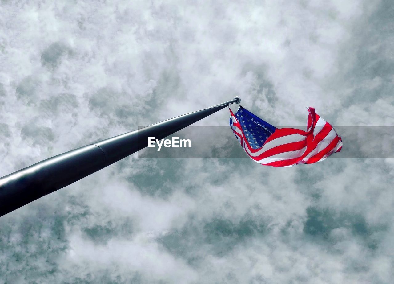 LOW ANGLE VIEW OF FLAGS AGAINST SKY