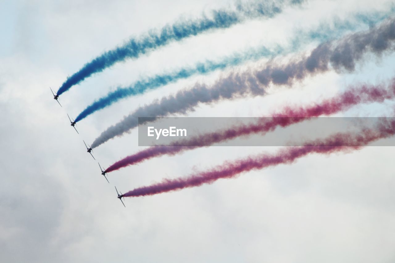 Low angle view of airshow against sky