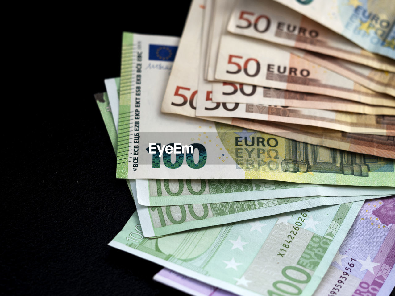 Stack of euro banknotes on black background