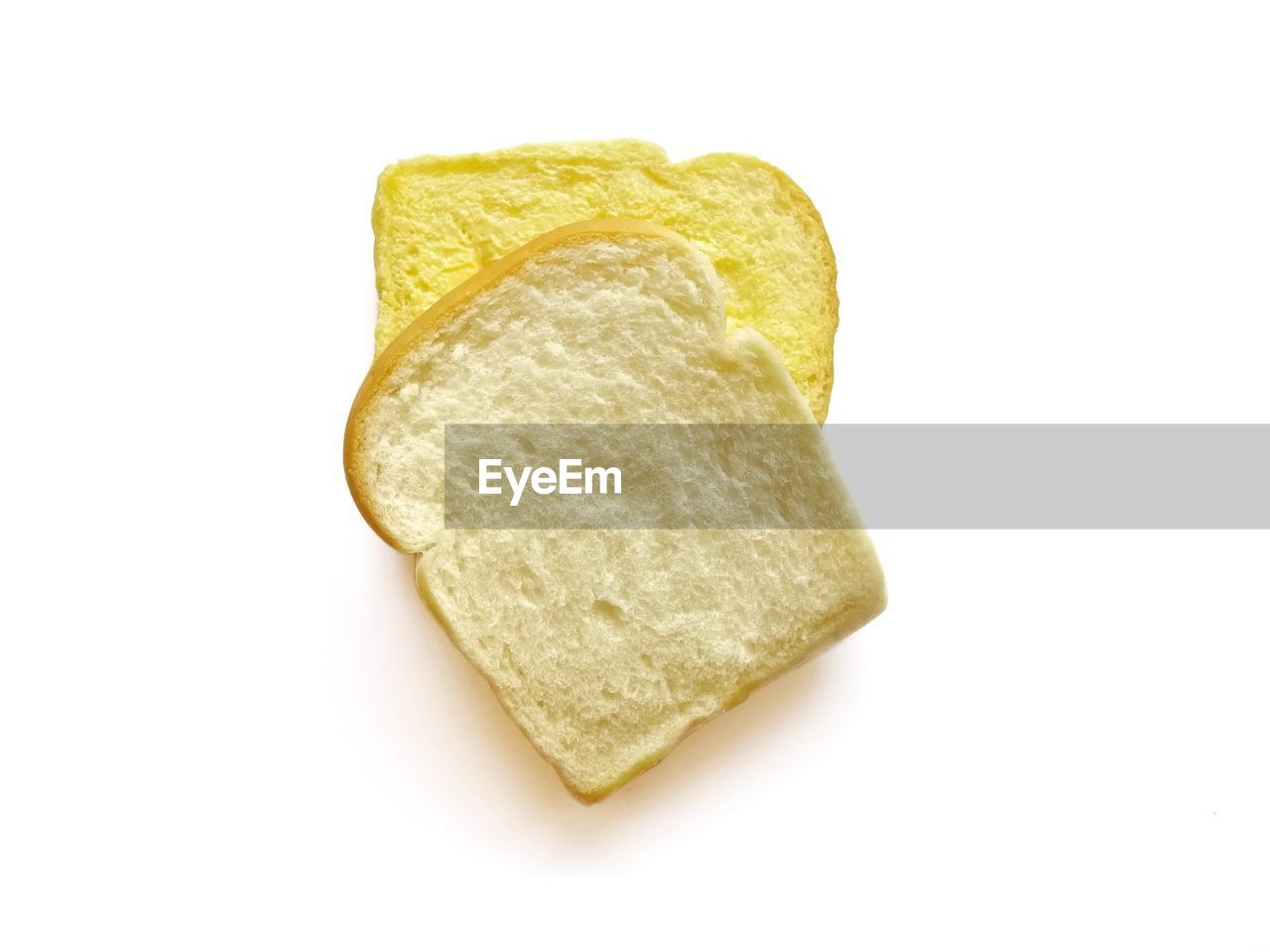 CLOSE-UP OF BREAD ON WHITE BACKGROUND