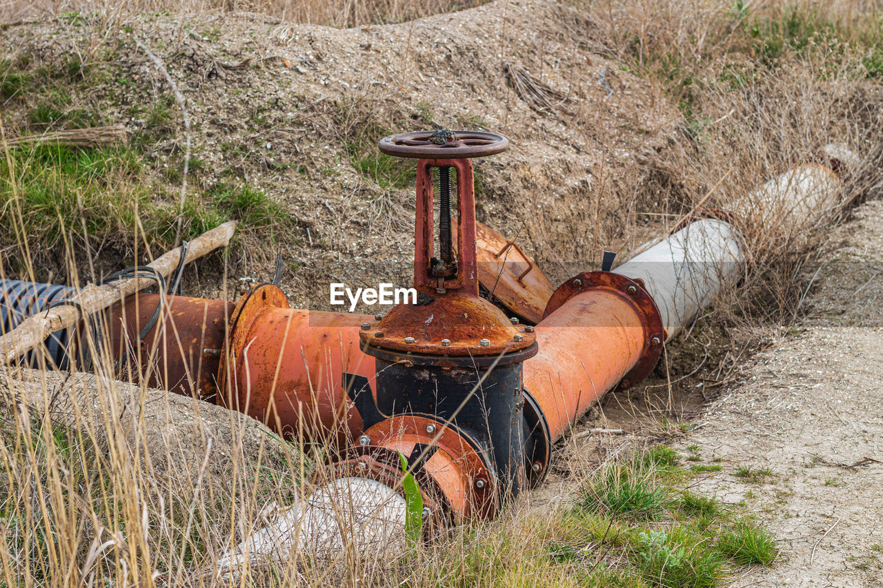 Old rusty wheel on field