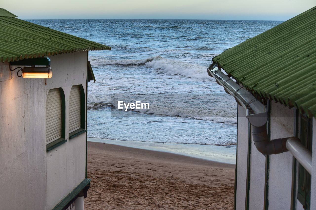 Lifeguard hut on beach against sky