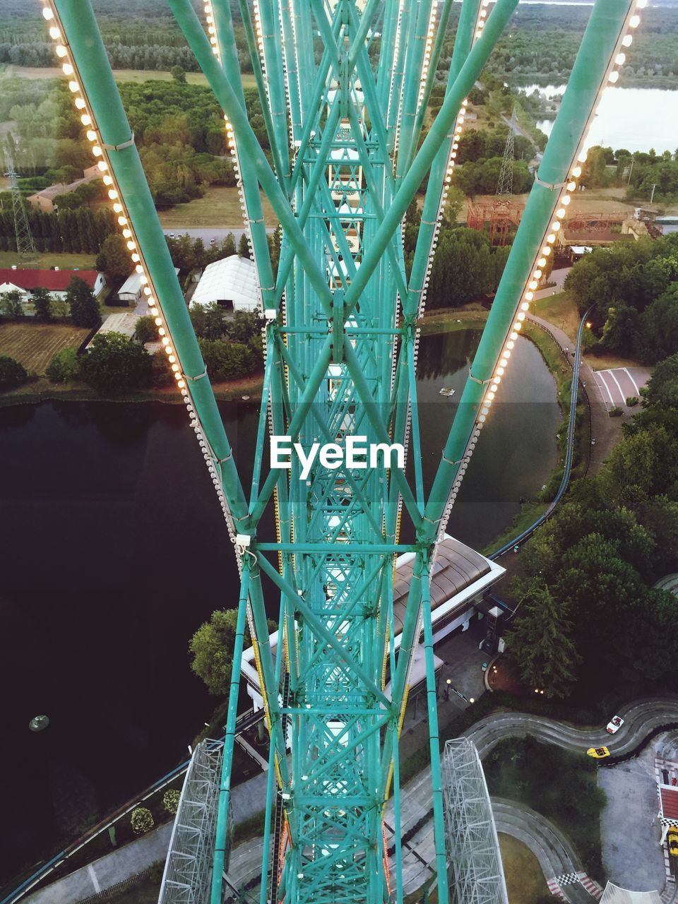 High angle view of rollercoaster at eurowheel by lake