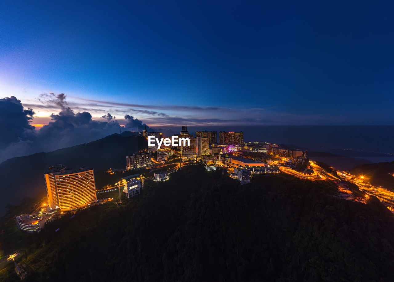 High angle view of illuminated buildings in city at night