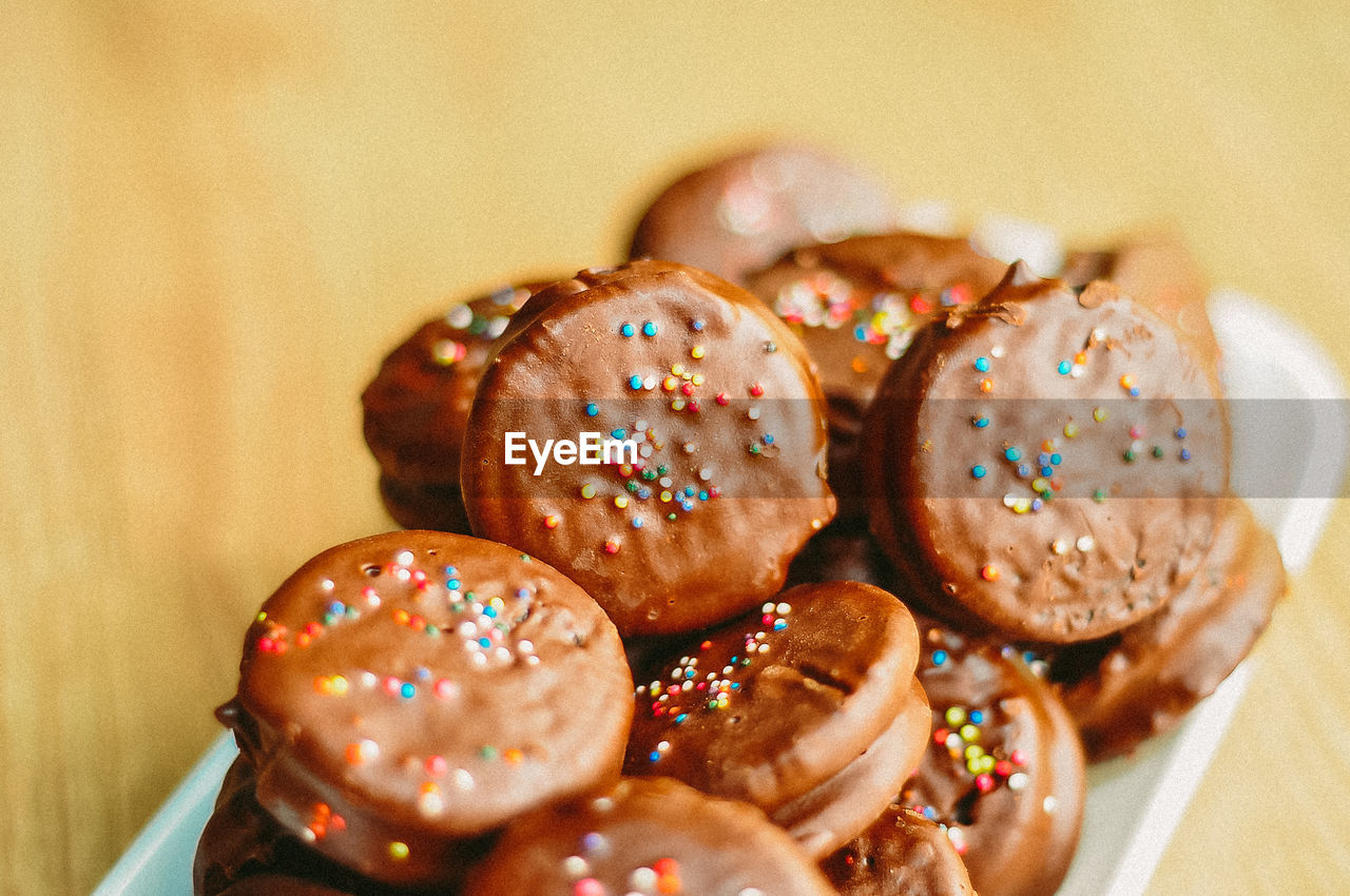 Gourmet chocolate covered oreos with colorful sprinkles on top.