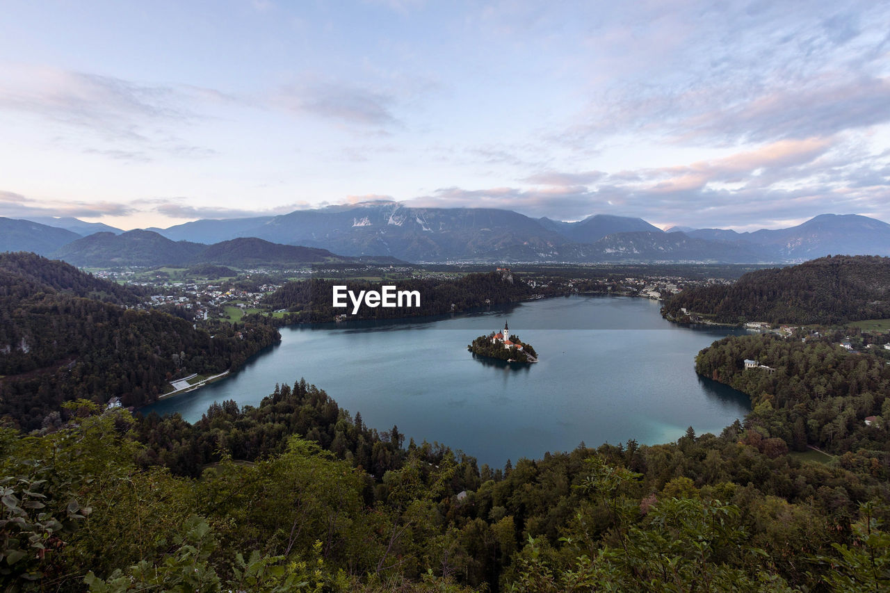 Scenic view of sea and mountains against sky