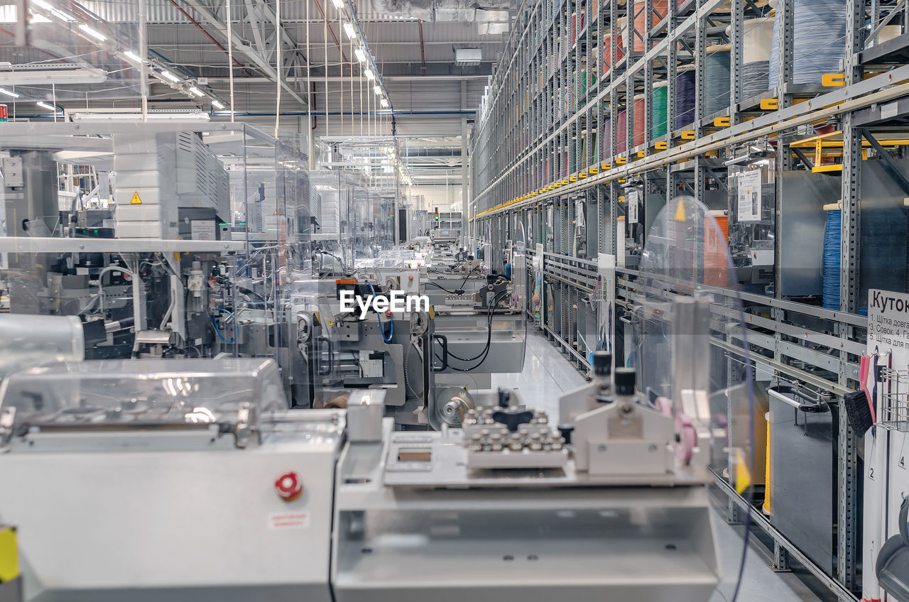 Interior of industrial workshop or shop inside for production of automotive wiring.