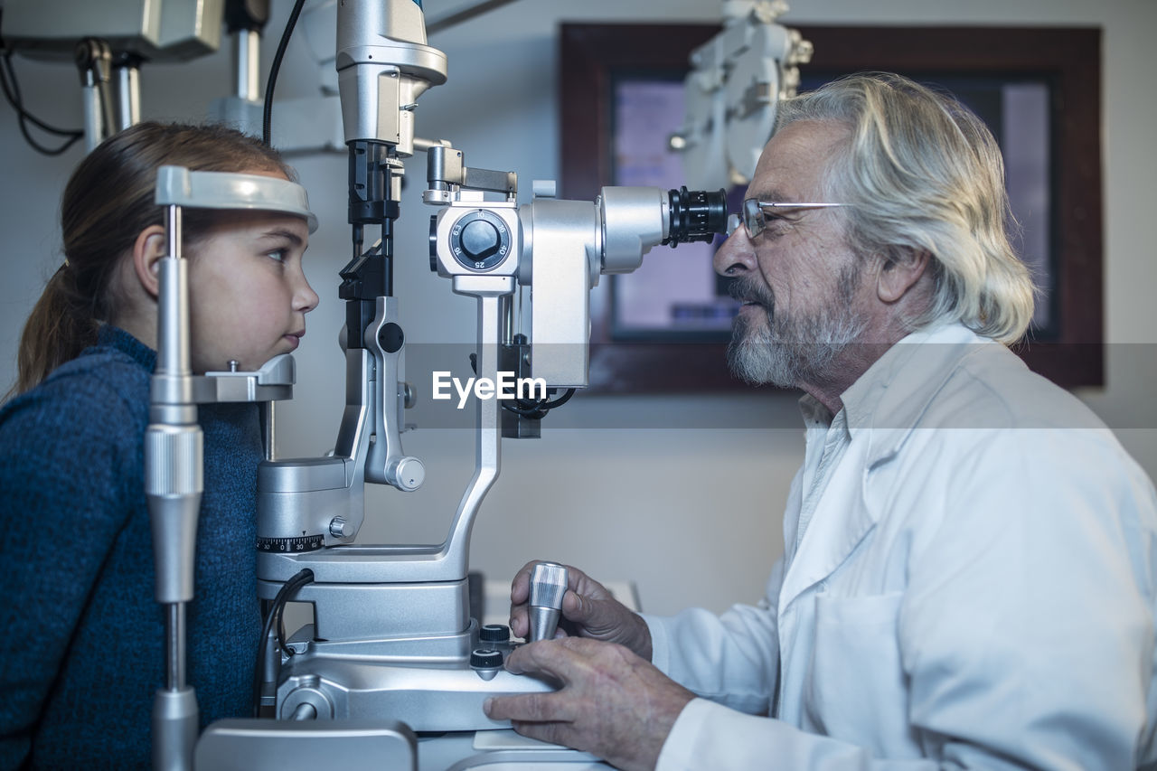 Girl doing eye test at the optometrist