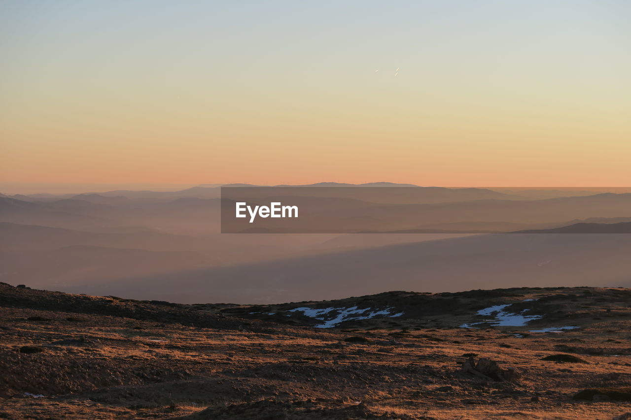 Scenic view of mountains against sky during sunset