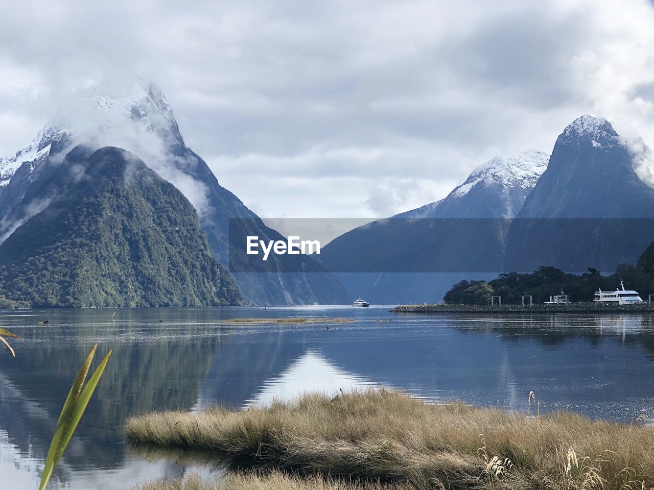 Scenic view of lake and mountains against sky