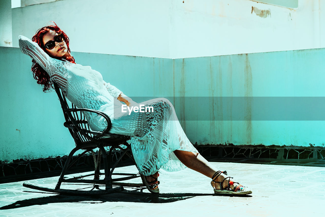 Portrait of beautiful woman sitting on rocking chair