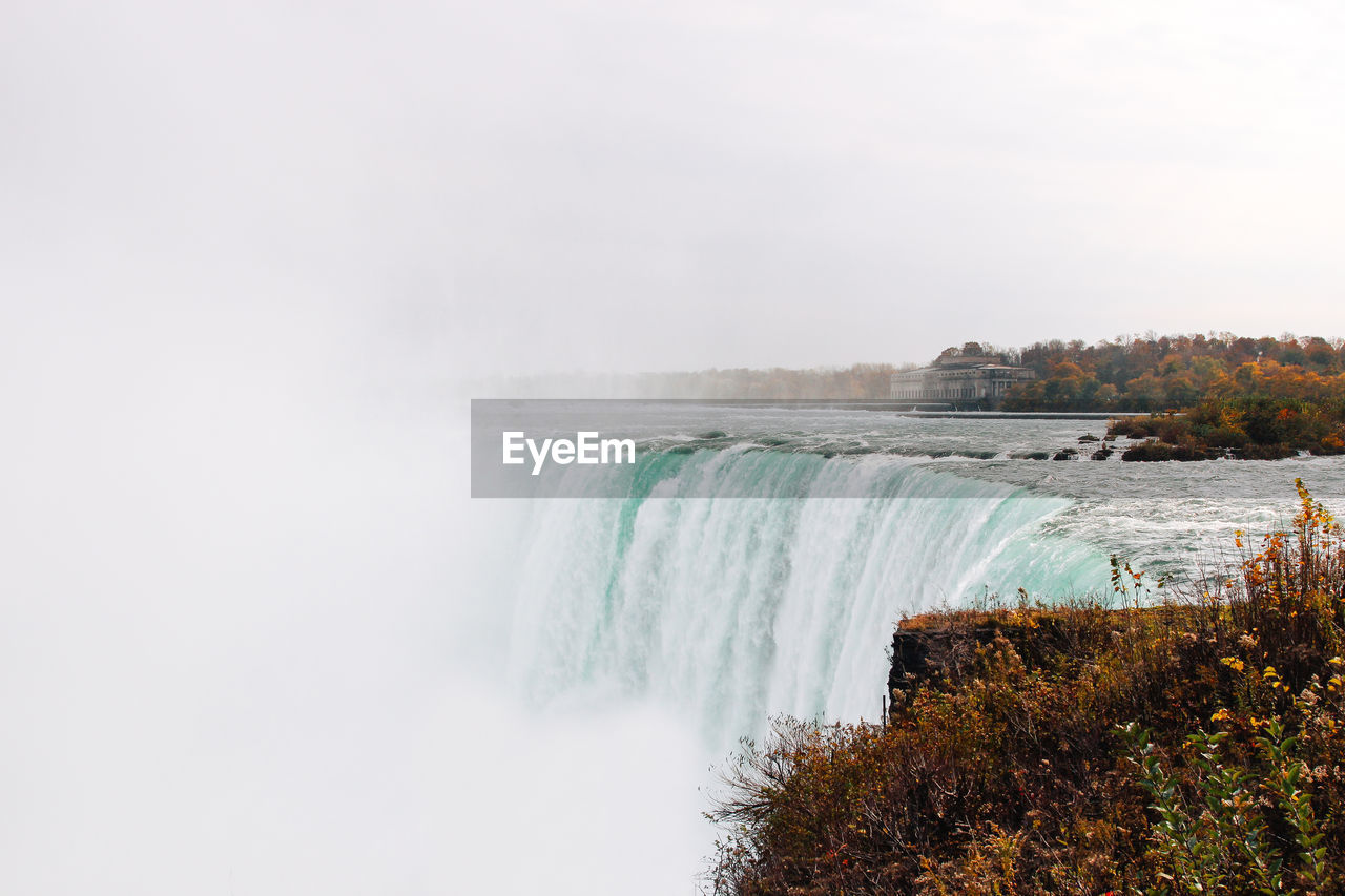 Scenic view of niagara falls against sky