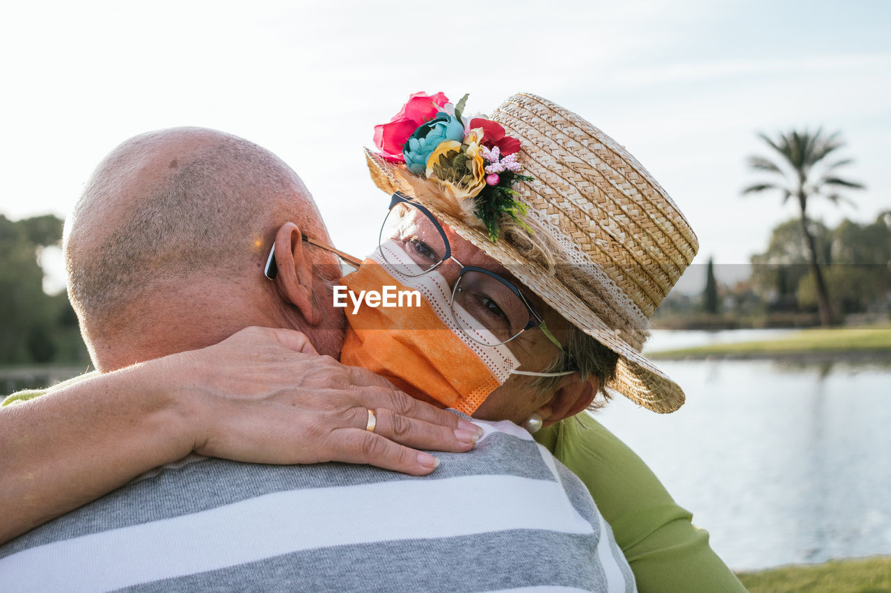 Portrait retired couple hug in a park