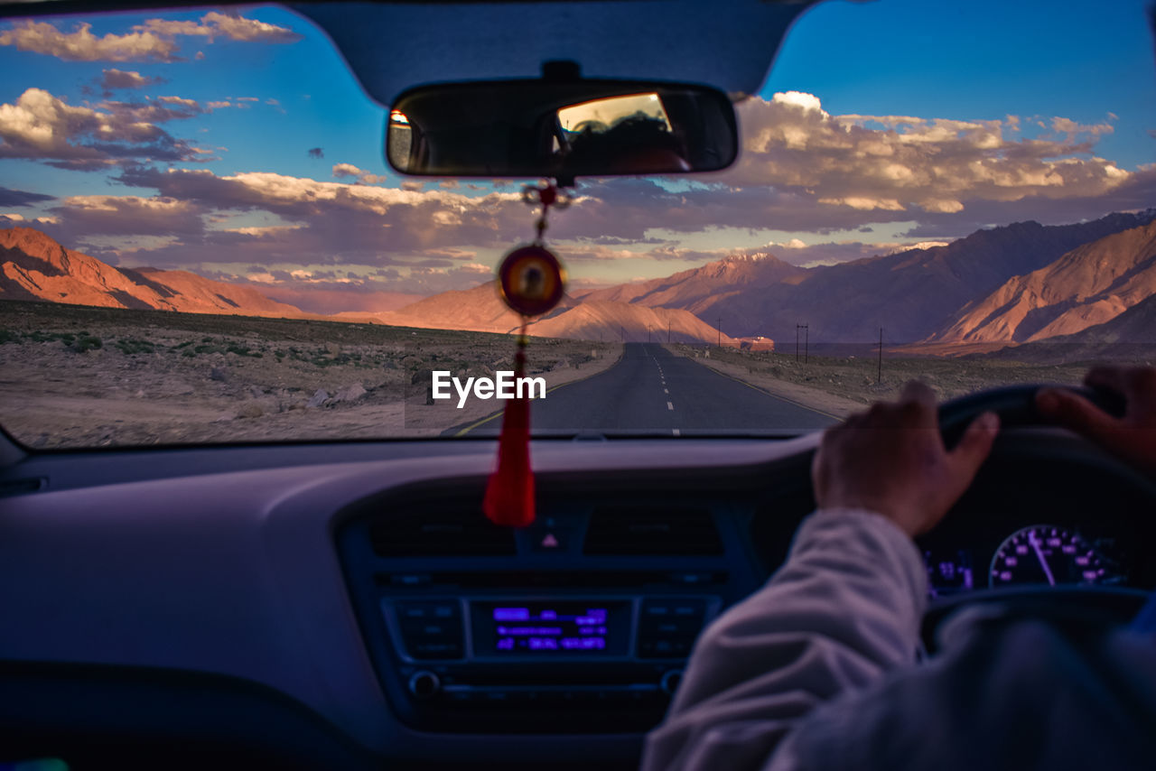 Cropped image of man driving car