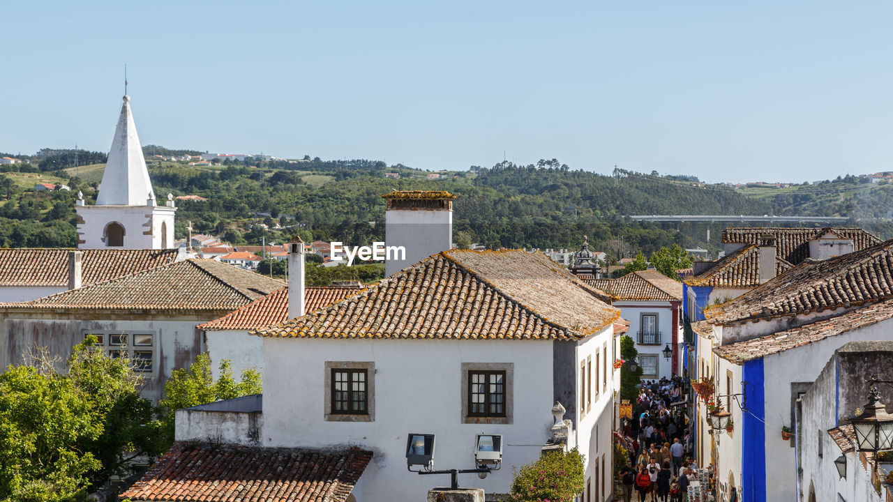 HOUSES AND TREES AGAINST CLEAR SKY