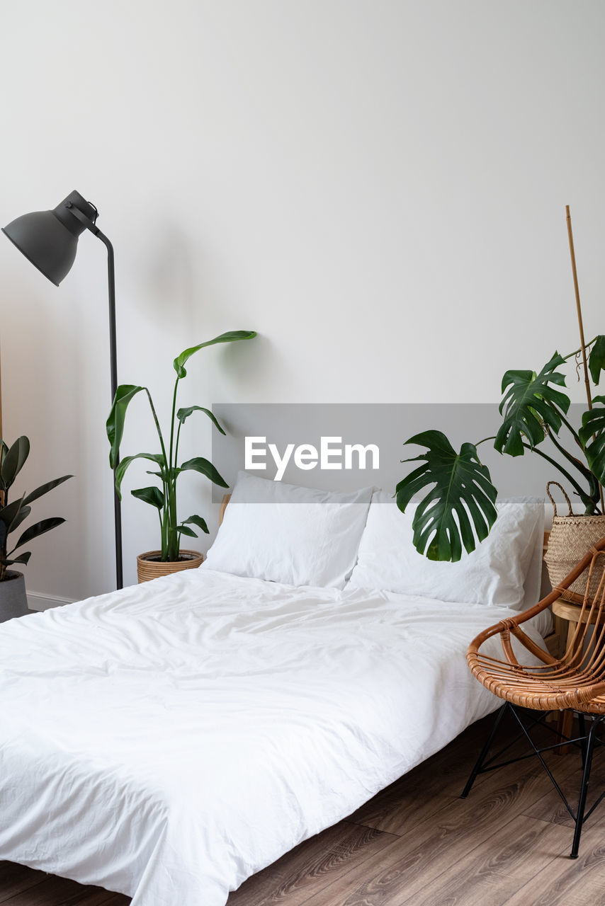 Space at home with bed, monstera and laundry baskets