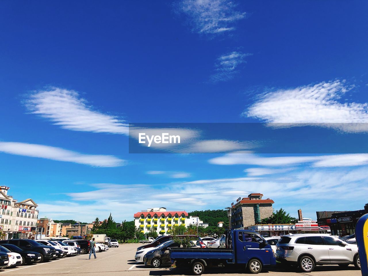 VIEW OF CITY STREET AGAINST BLUE SKY