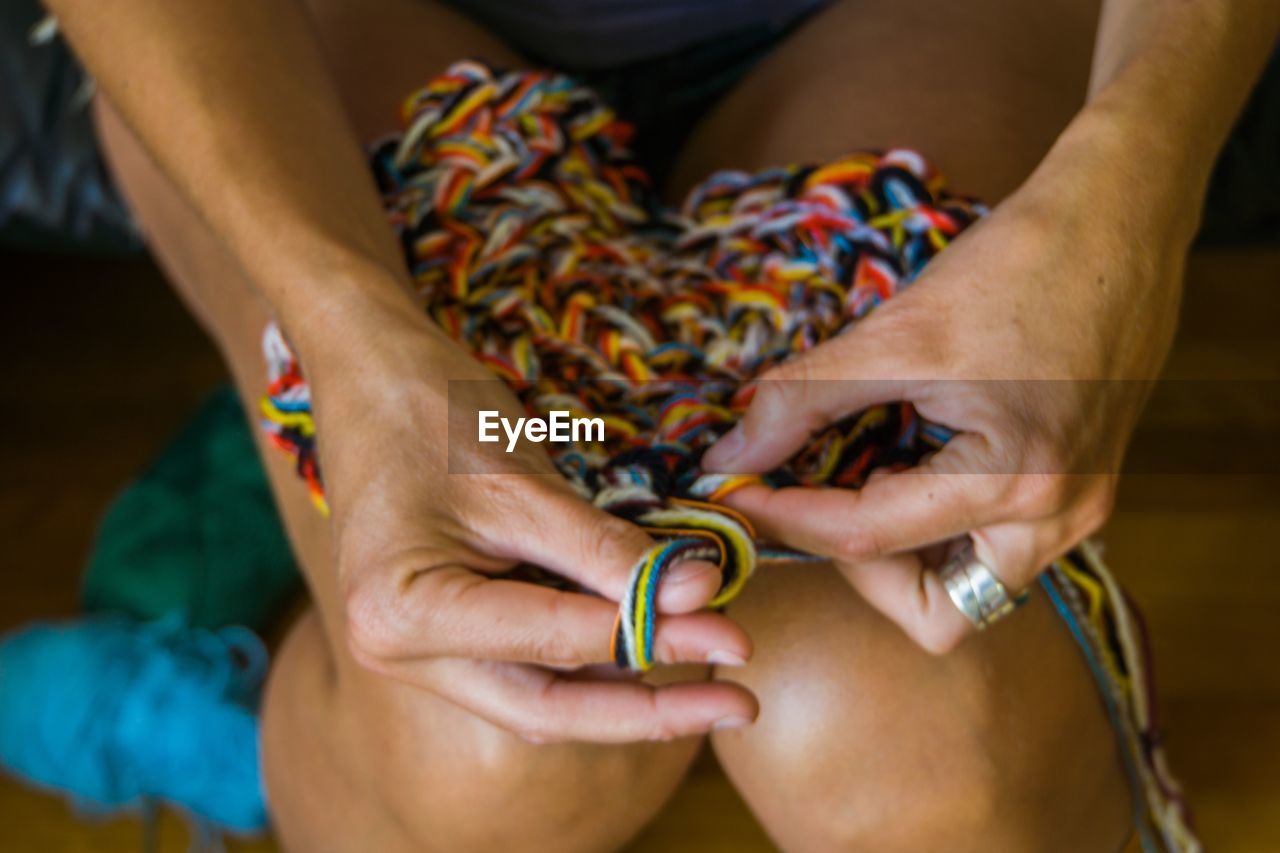 Midsection of woman holding colorful wool