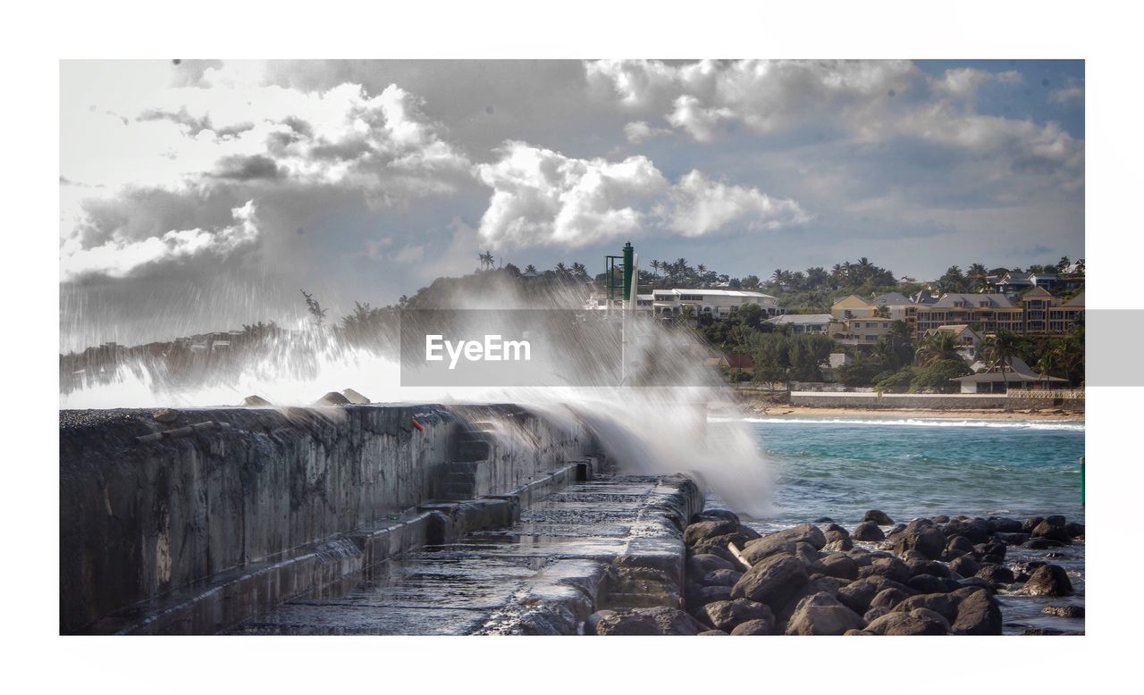 SCENIC VIEW OF SEA AND ROCKS AGAINST SKY