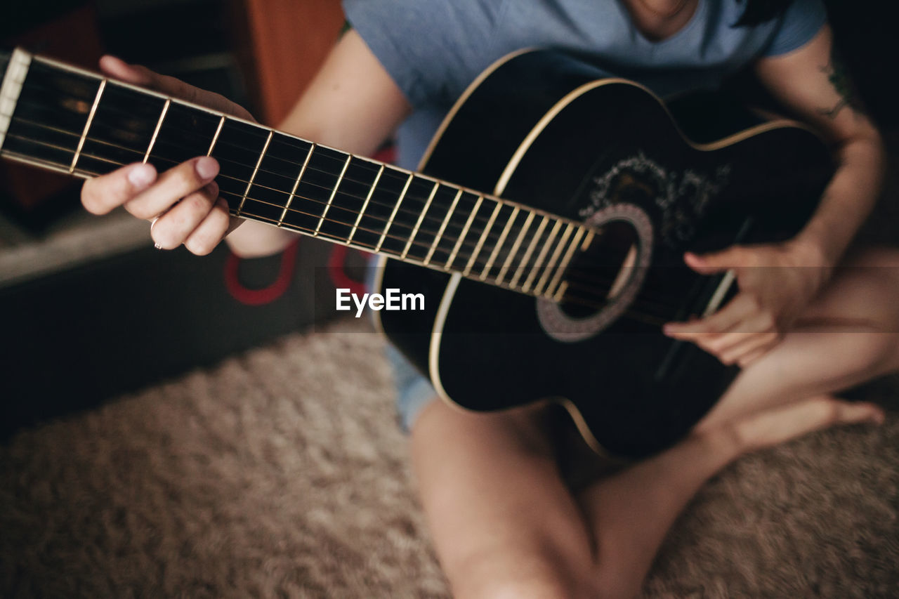 Close-up of hands playing guitar