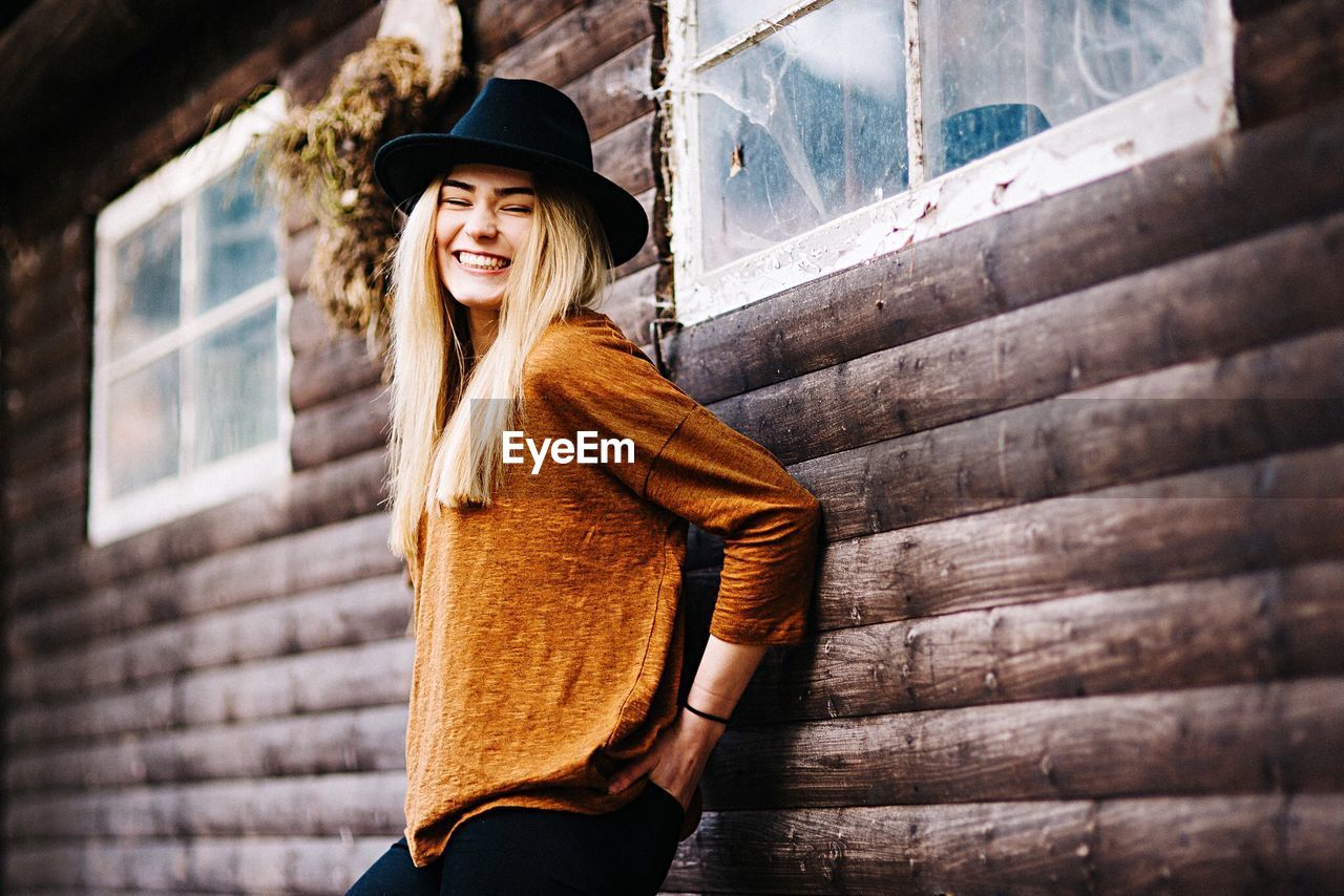 PORTRAIT OF YOUNG WOMAN WEARING HAT