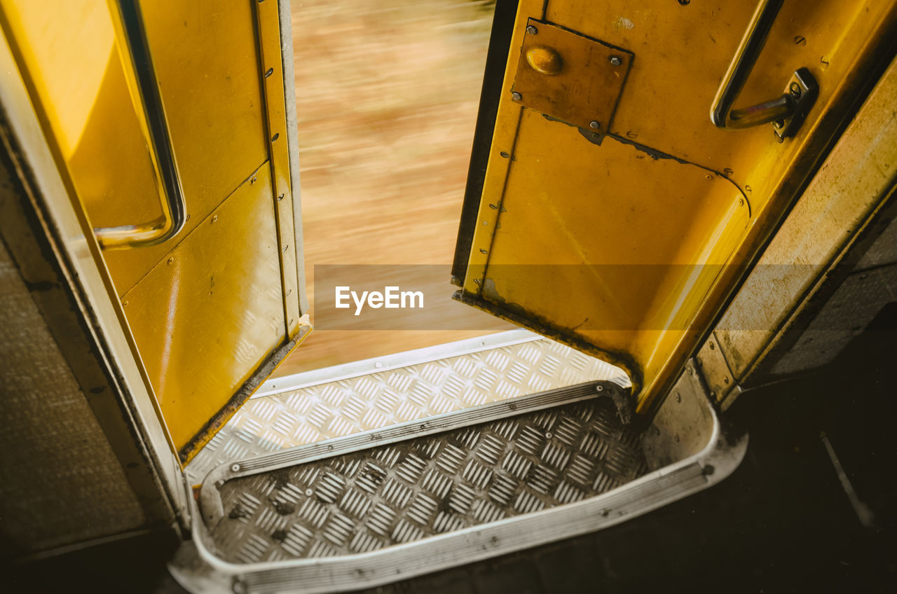 High angle view of yellow open bus door
