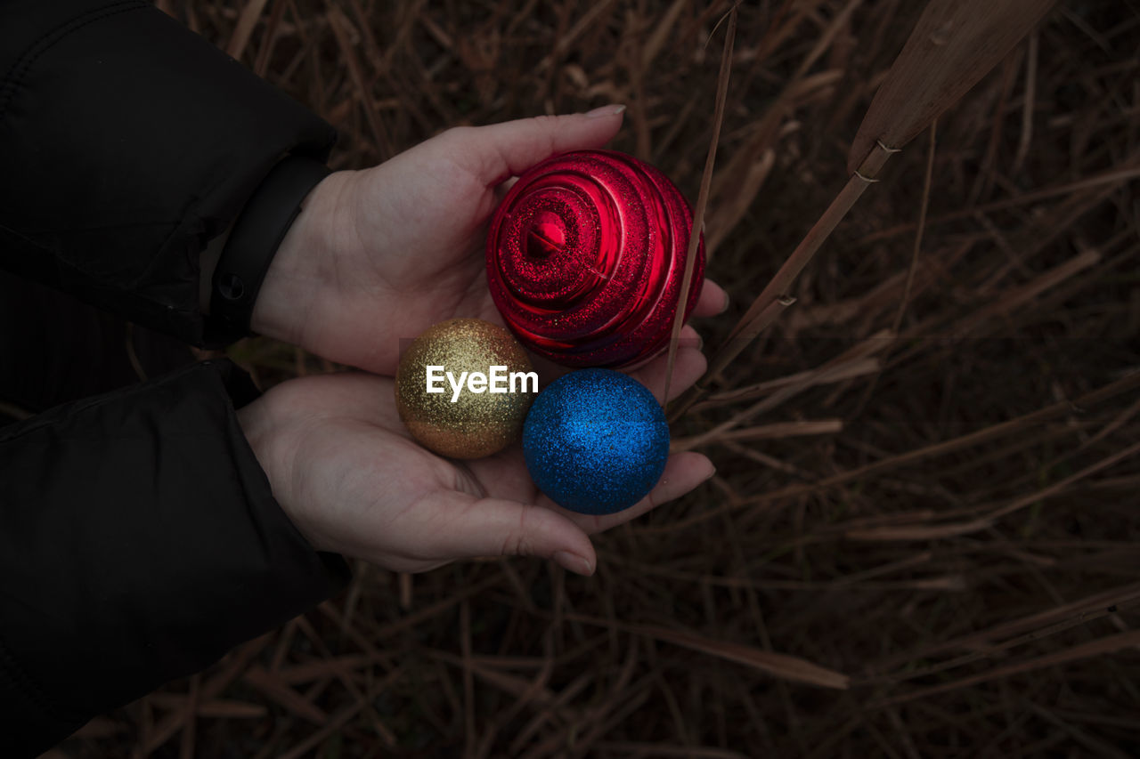 High angle view of person holding christmas ornament