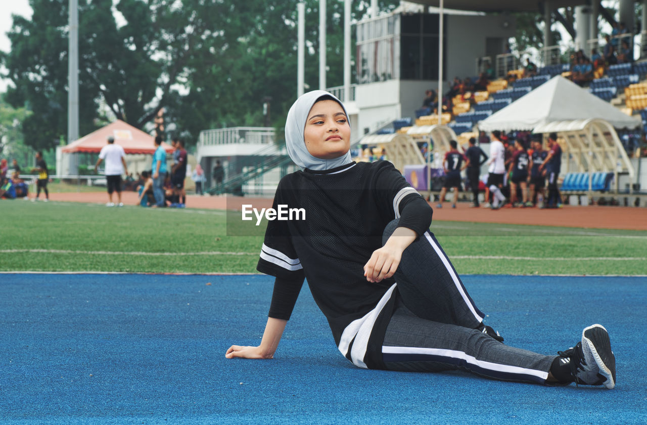 Athlete sitting on running track